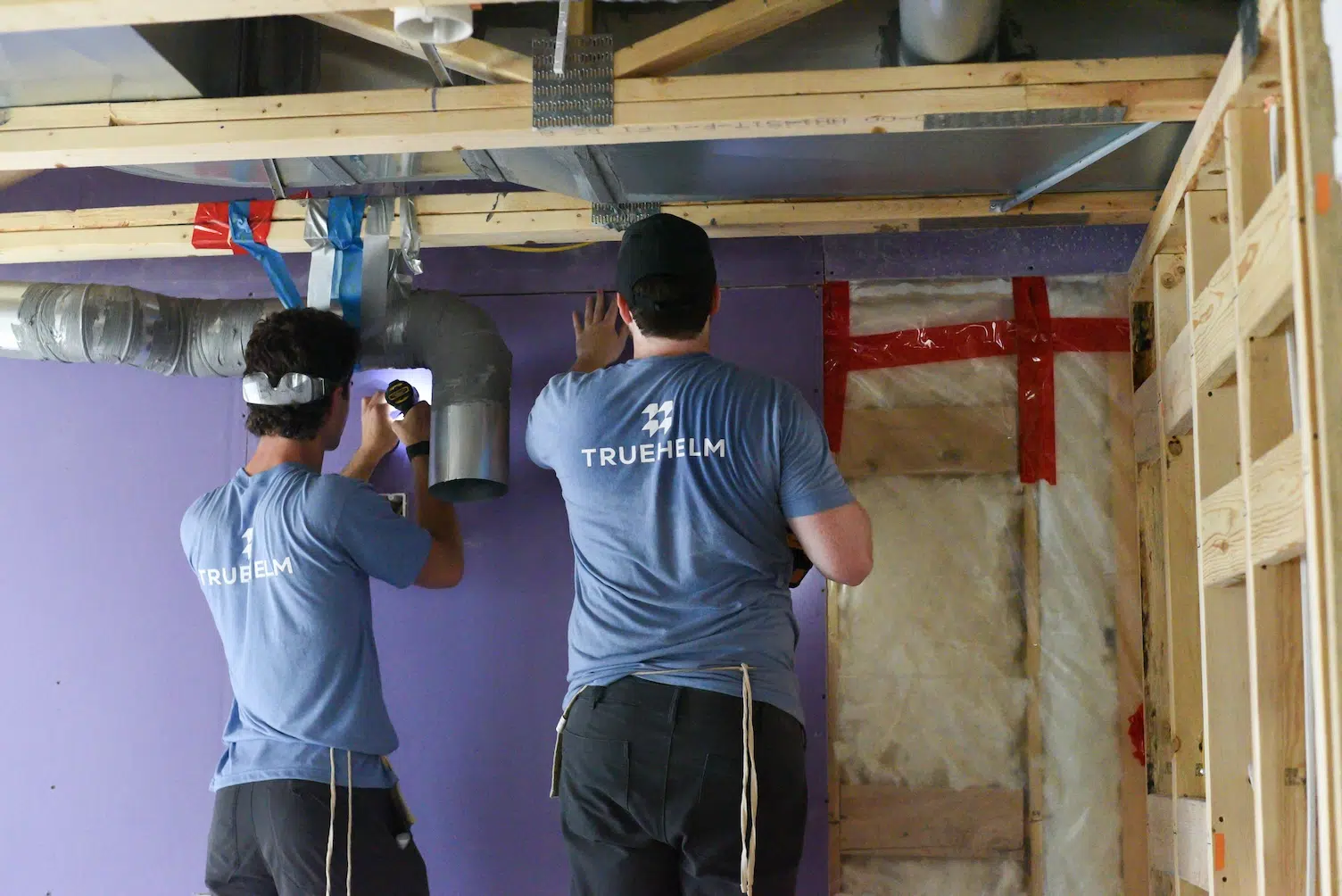 Two Truehelm workers doing handy work.